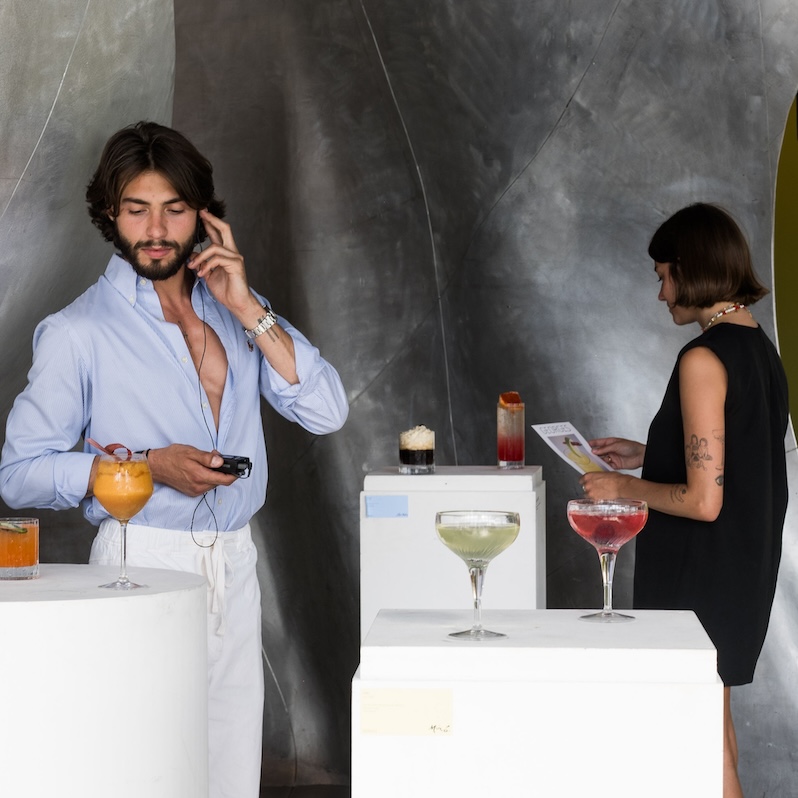 Elegant man enjoying a cocktail at Georges restaurant, a sky bar in Paris with panoramic views and chic ambiance.